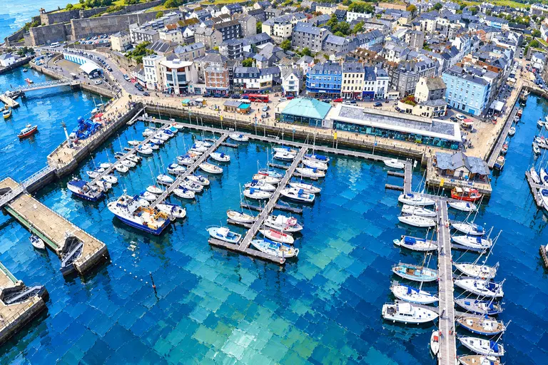 Painting of Plymouth Sound (or the Barbican lock) with boats and the historic waterfront.